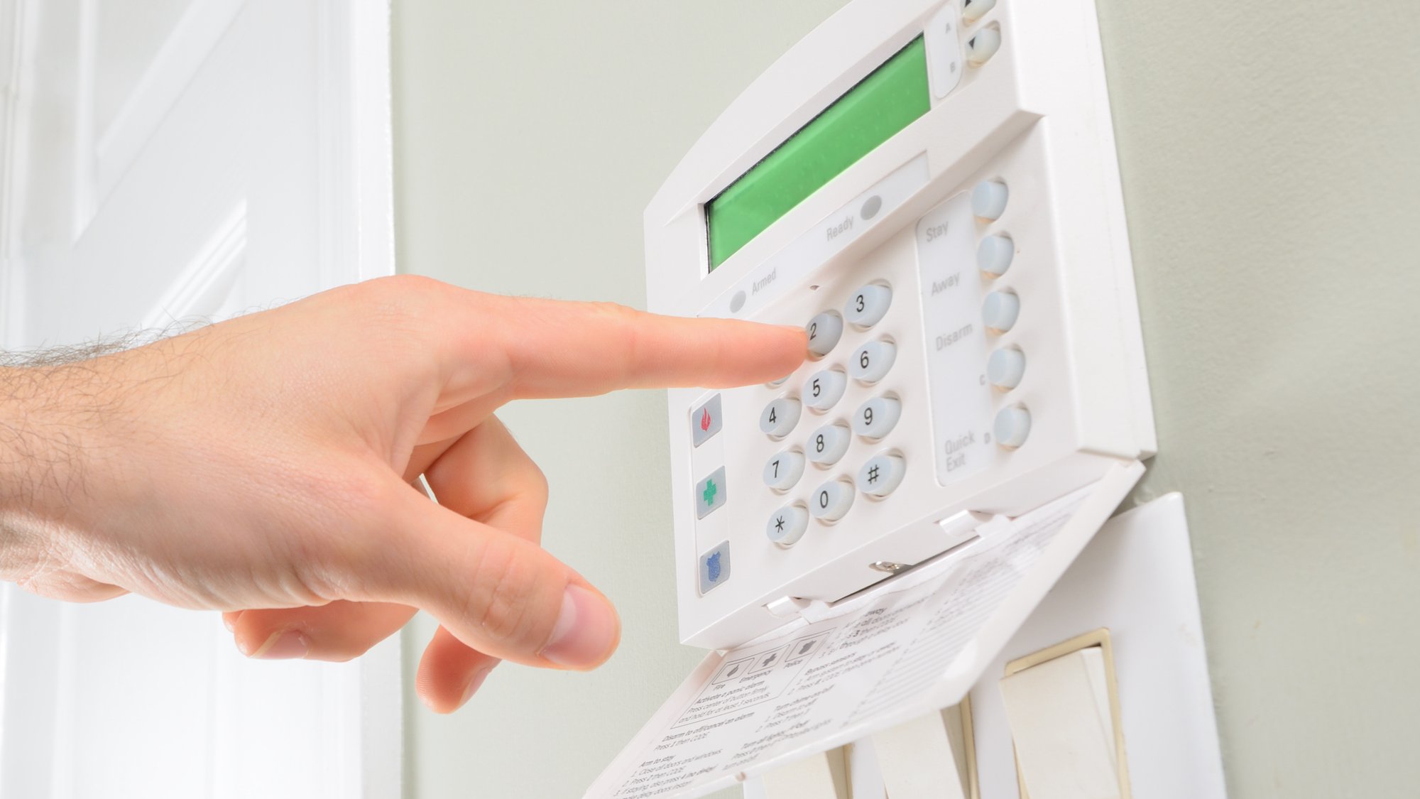 pressing the code on a house alarm