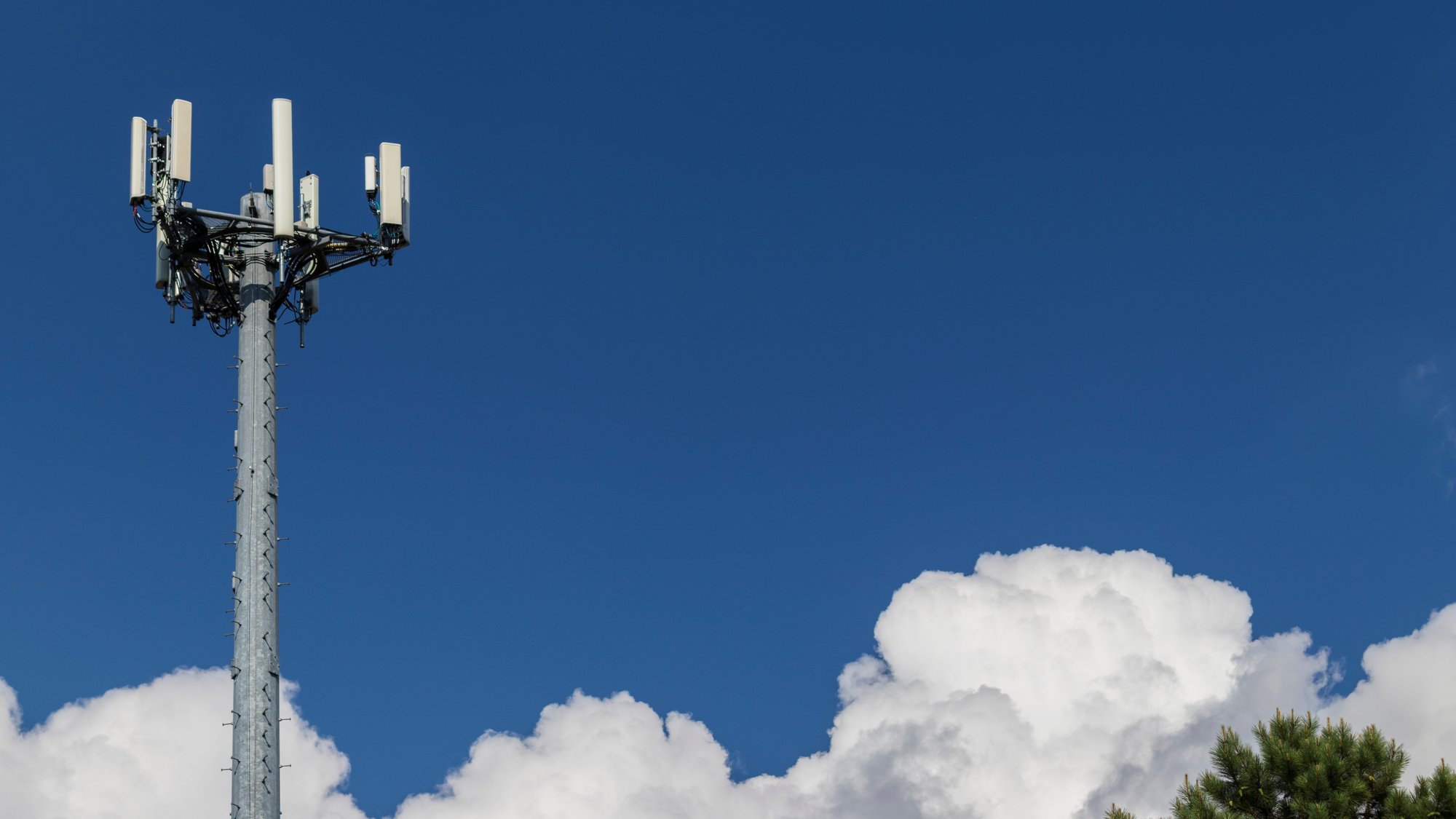 Technology Communication Mobile Telephone Cellular Wireless Network GSM Signal Tower Antenna Against Blue Sky Puffy Cloud Bac