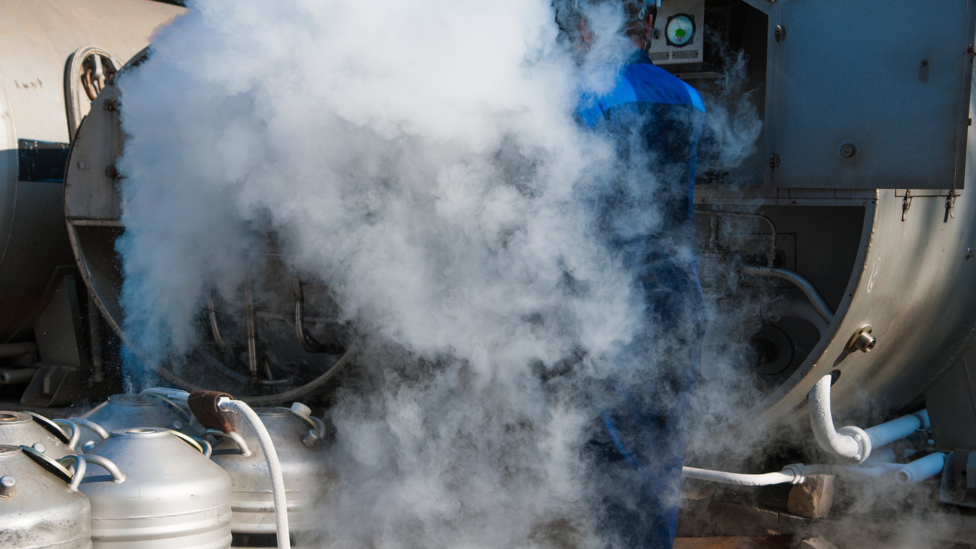 Young engineer fill with liquid nitrogen with Nitrogen storage tank at new factory