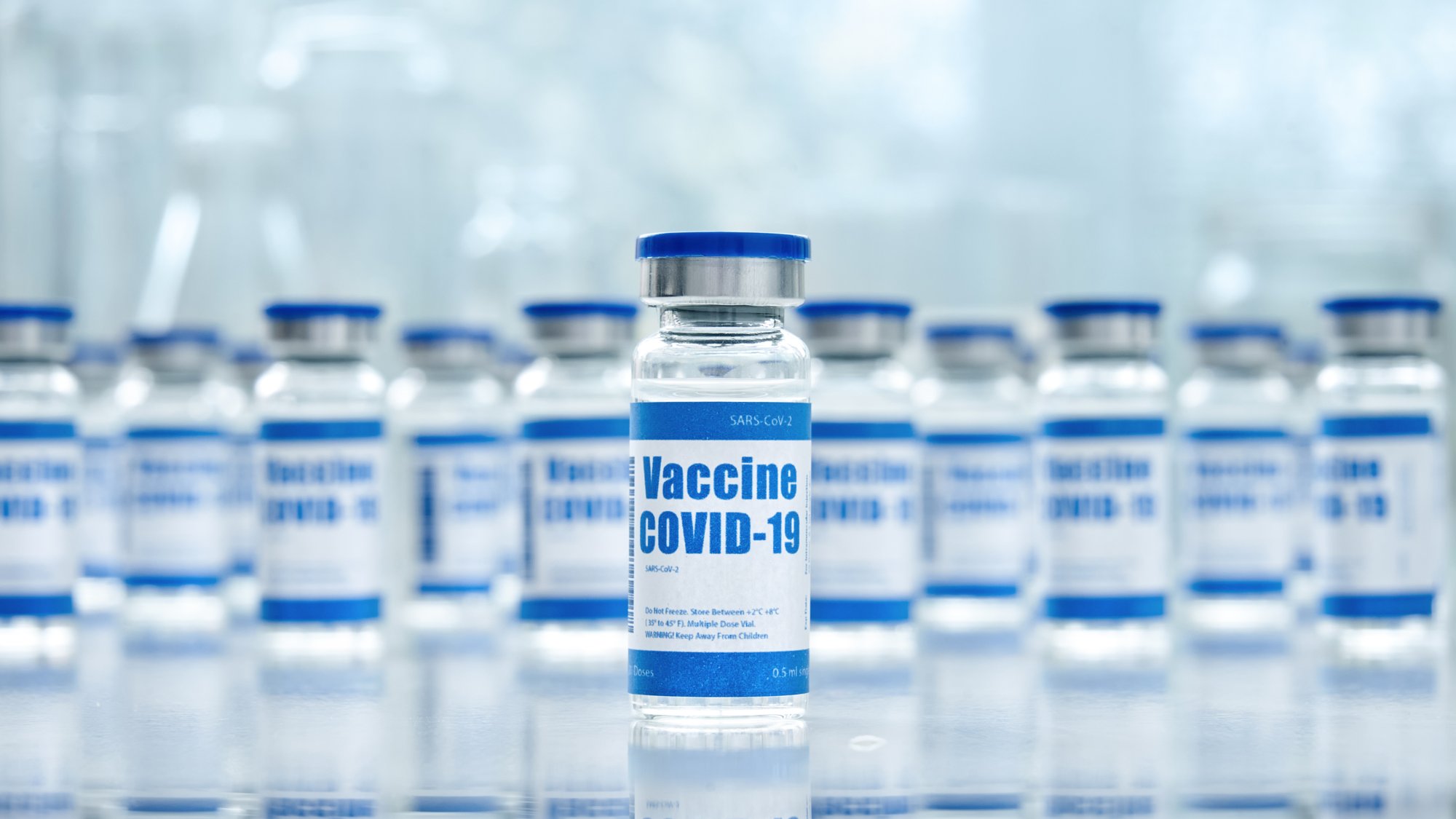 Covid 19 corona virus vaccine vial bottles for intramuscular injections on medical pharmaceutical industry background. Corona